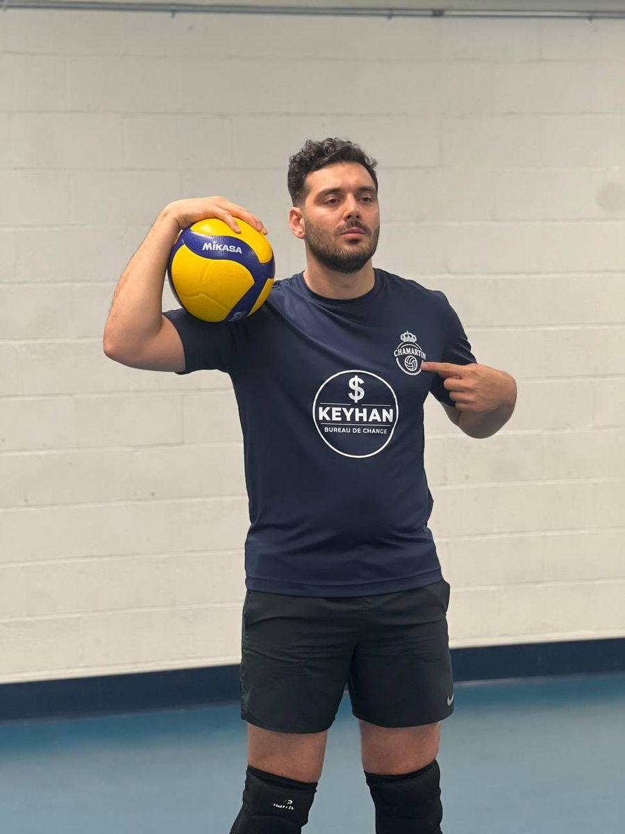 Coach Moeen with volleyball on his shoulder